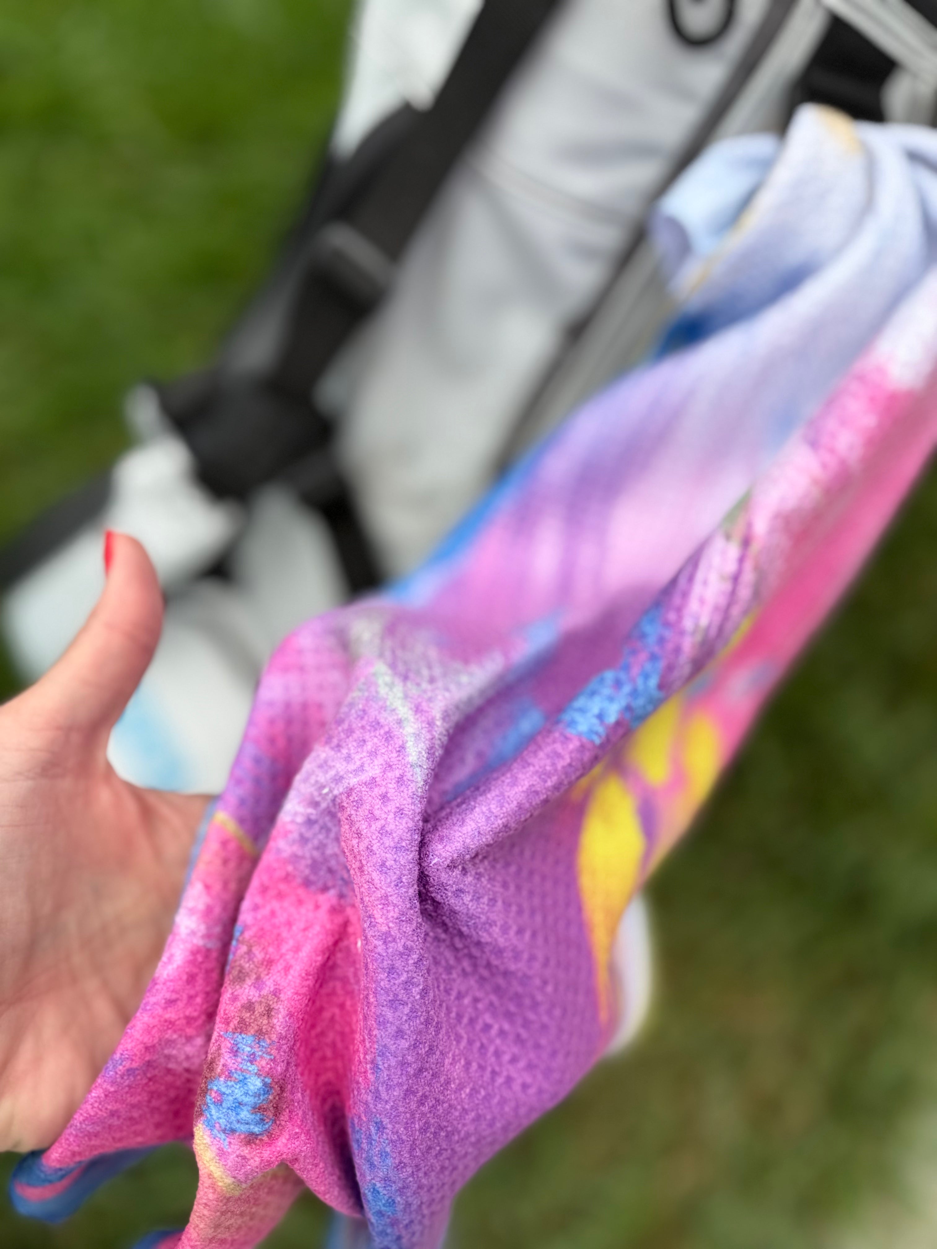 Colorful abstract floral quick-dry towel hanging on a golf bag. Bloom design is based on Isaiah 35:2.