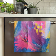 Colorful abstract floral quick-dry towel hanging on the dishwasher handle. Bloom design is based on Isaiah 35:2.