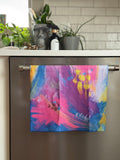 Colorful abstract floral quick-dry towel hanging on the dishwasher handle. Bloom design is based on Isaiah 35:2.