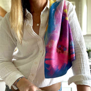 Colorful abstract floral quick-dry towel over a woman's shoulder in the kitchen. Bloom design is based on Isaiah 35:2.