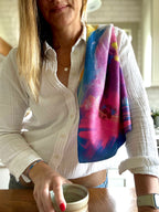 Colorful abstract floral quick-dry towel over a woman's shoulder in the kitchen. Bloom design is based on Isaiah 35:2.