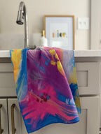 Colorful abstract floral quick-dry towel hanging by laundry room sink. Bloom design is based on Isaiah 35:2.