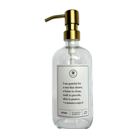 Clear glass I Am Grateful Lotion Gratitude Bottle with gold pump.