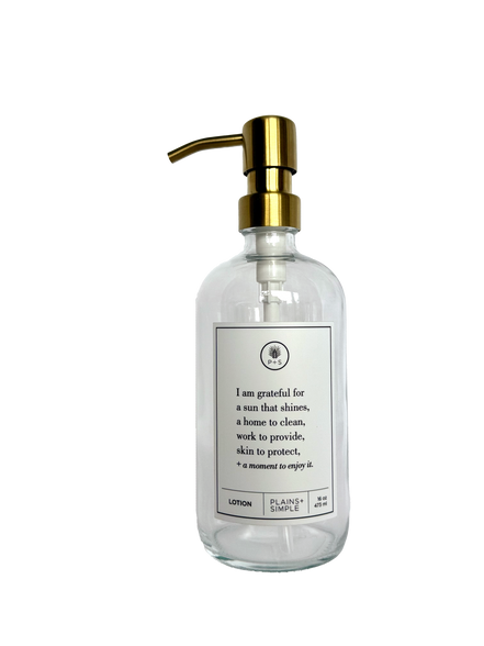 Clear glass I Am Grateful Lotion Gratitude Bottle with gold pump.