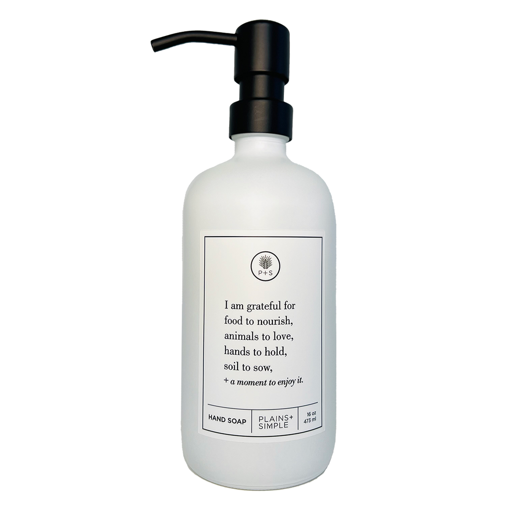 White glass I Am Grateful hand soap Gratitude Bottle with black pump.