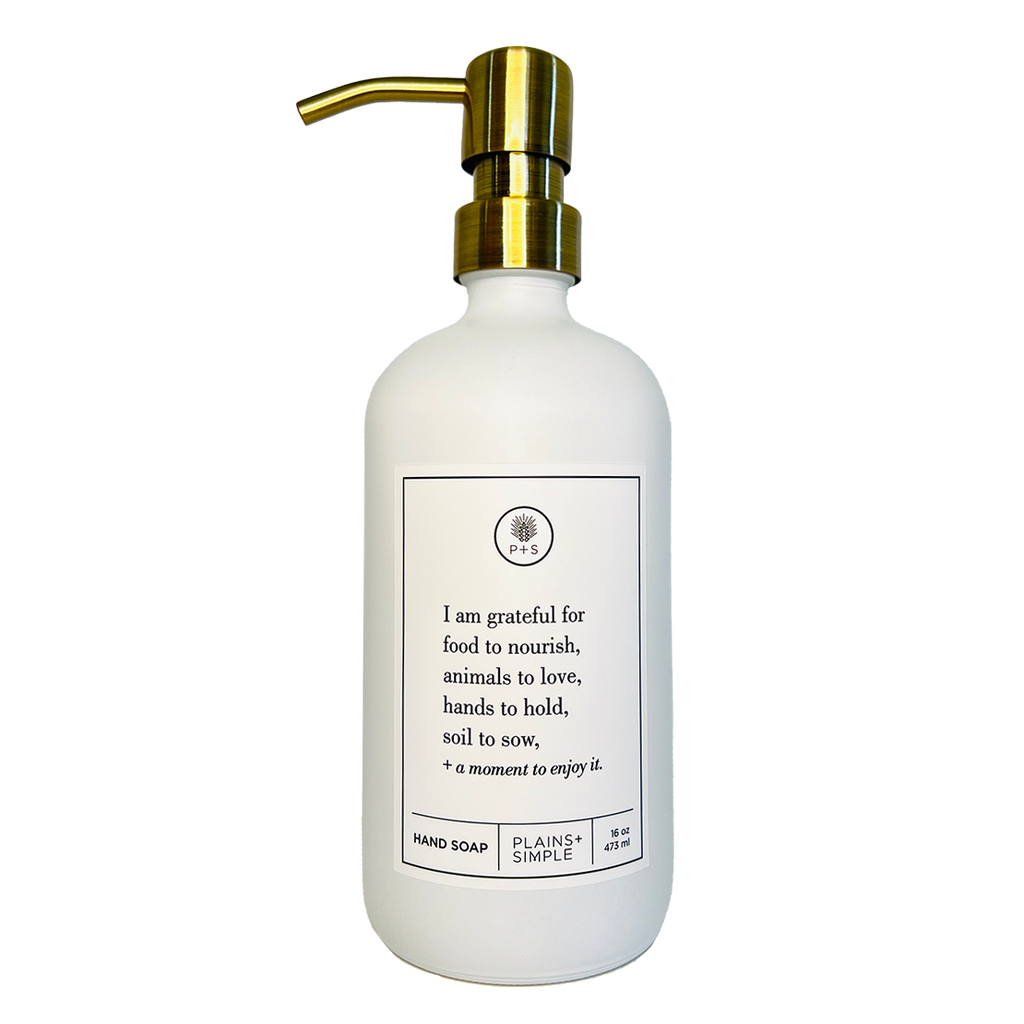 White glass I Am Grateful hand soap Gratitude Bottle with gold pump.