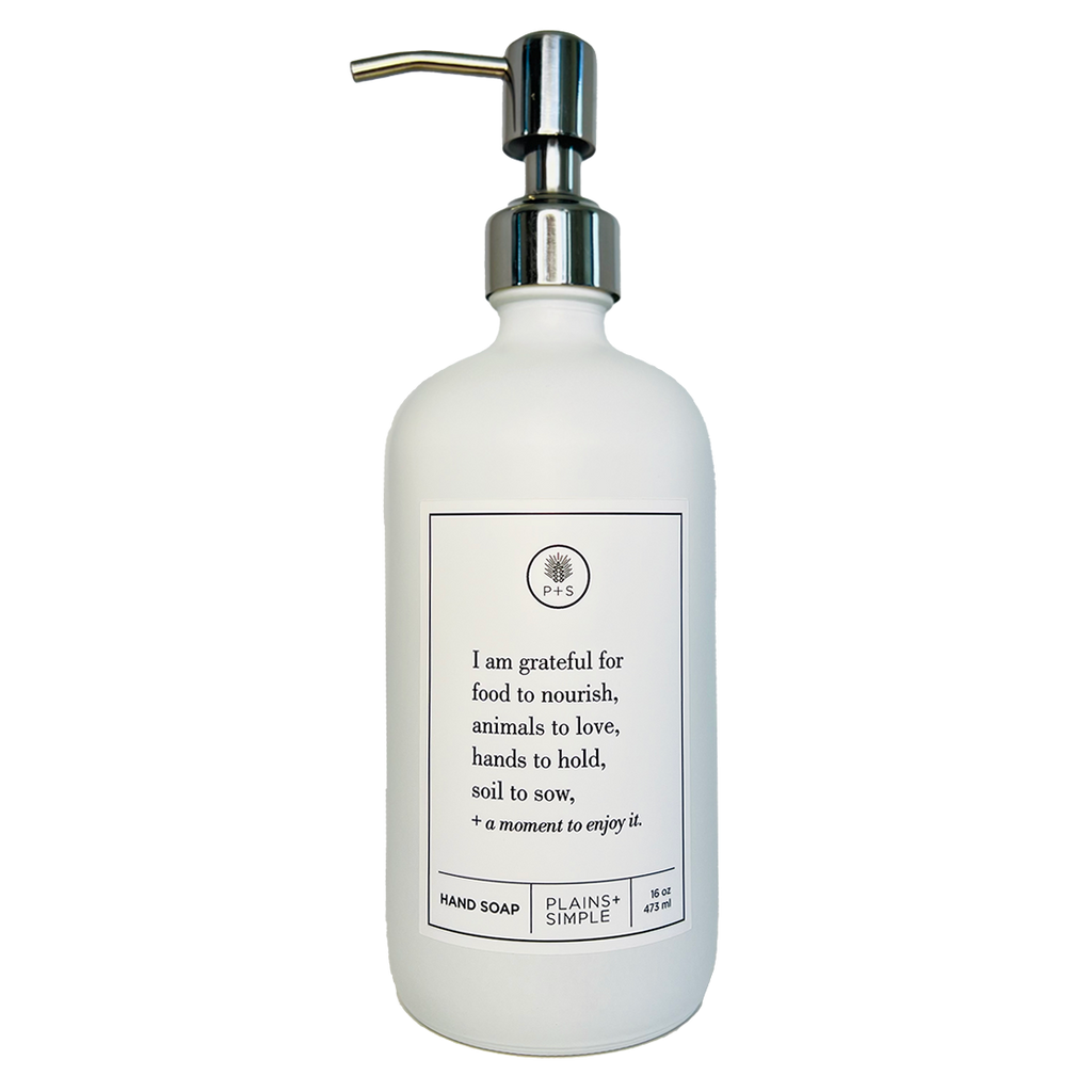 White glass I Am Grateful hand soap Gratitude Bottle with silver pump.
