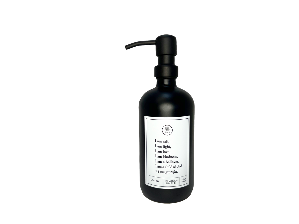 Black glass I am Salt & Light lotion Gratitude Bottle with black pump.
