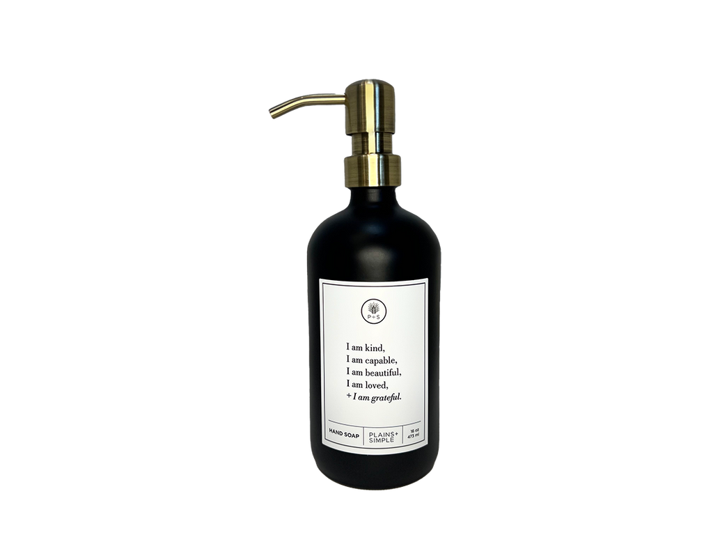 Black glass I am Kind hand soap Gratitude Bottle with gold pump.