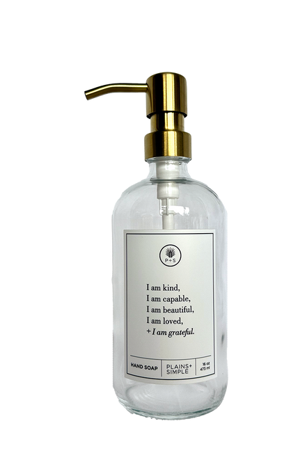 Clear glass I am Kind hand soap Gratitude Bottle with gold pump.