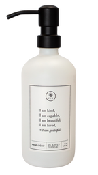 White glass I am Kind hand soap Gratitude Bottle with black pump.