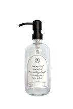 Clear glass Love Is... multipurpose Gratitude Bottle with black pump.