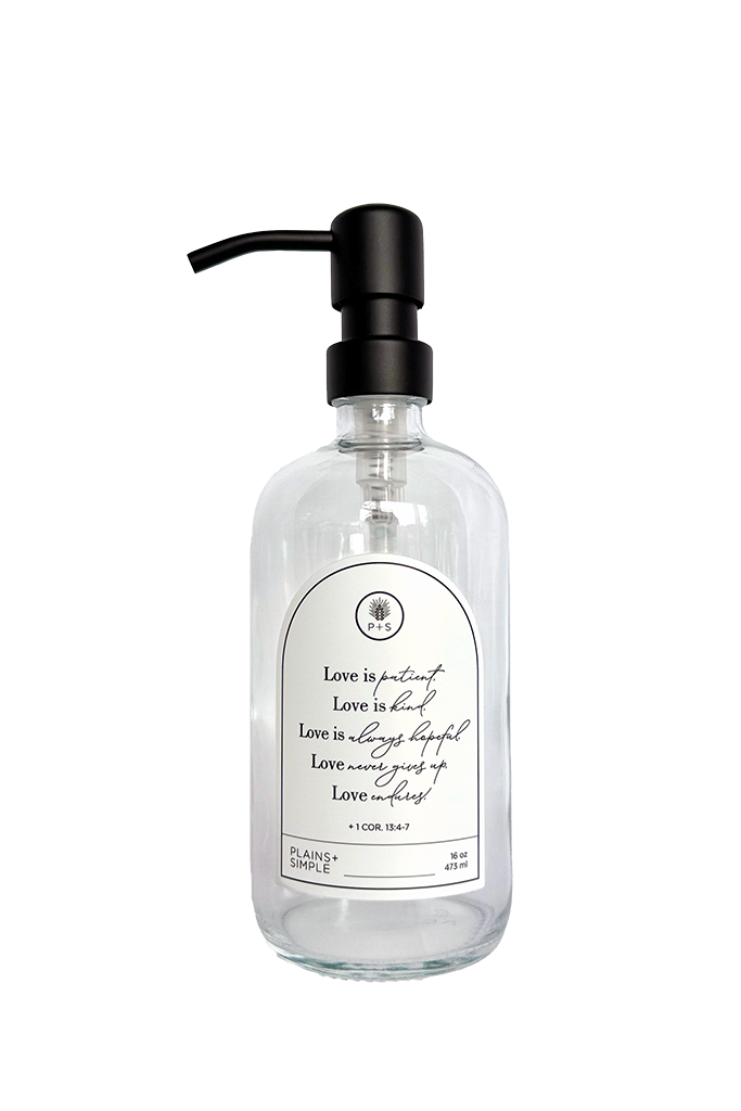 Clear glass Love Is... multipurpose Gratitude Bottle with black pump.