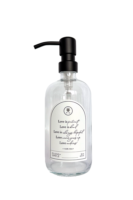 Clear glass Love Is... multipurpose Gratitude Bottle with black pump.