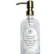 Clear glass Love Is... multipurpose Gratitude Bottle with gold pump.