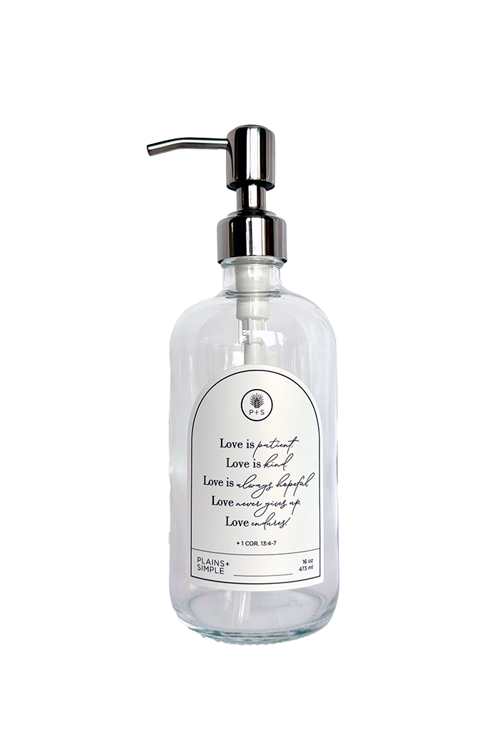 Clear glass Love Is... multipurpose Gratitude Bottle with silver pump.