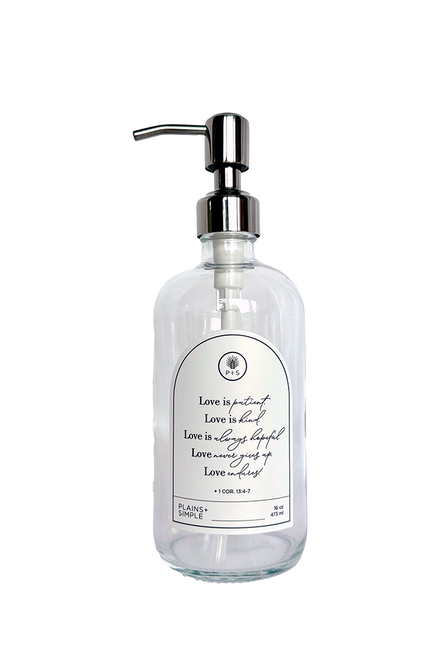 Clear glass Love Is... multipurpose Gratitude Bottle with silver pump.