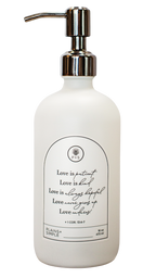 White glass Love Is... multipurpose Gratitude Bottle with silver pump.