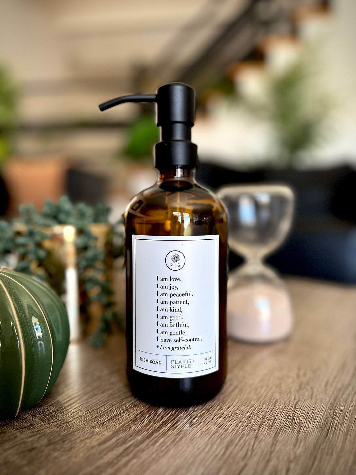 Amber glass Fruits of the Spirit dish soap Gratitude Bottle with black pump with beautiful decor items.