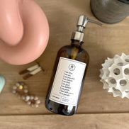 Amber glass Fruits of the Spirit dish soap Gratitude Bottle with silver pump surrounded by decor & jewelry.