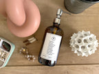 Amber glass Fruits of the Spirit dish soap Gratitude Bottle with silver pump surrounded by decor & jewelry.