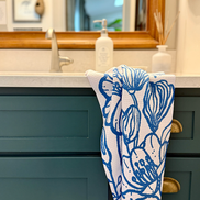 Blue & white floral pattern Presence quick-dry hand towel by bathroom sink.