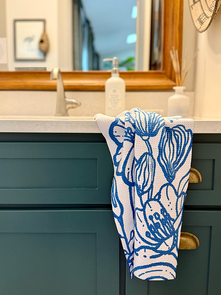 Blue & white floral pattern Presence quick-dry hand towel by bathroom sink.