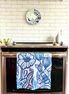 Blue & white, floral patterned, Presence quick dry towel hanging on a stove brightening up a kitchen.
