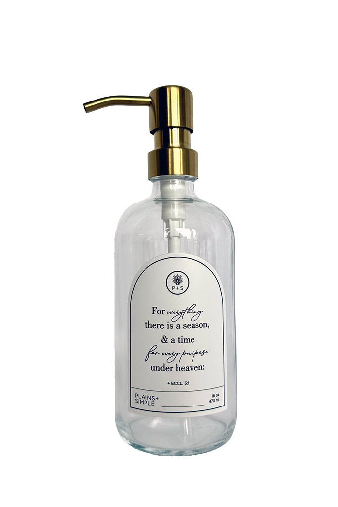 Clear glass Seasons multipurpose Gratitude Bottle with gold pump.
