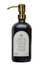 Black glass Trust multipurpose Gratitude Bottle with gold pump.