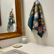 Wildflower multipurpose hand towel hanging in bathroom near the sink.