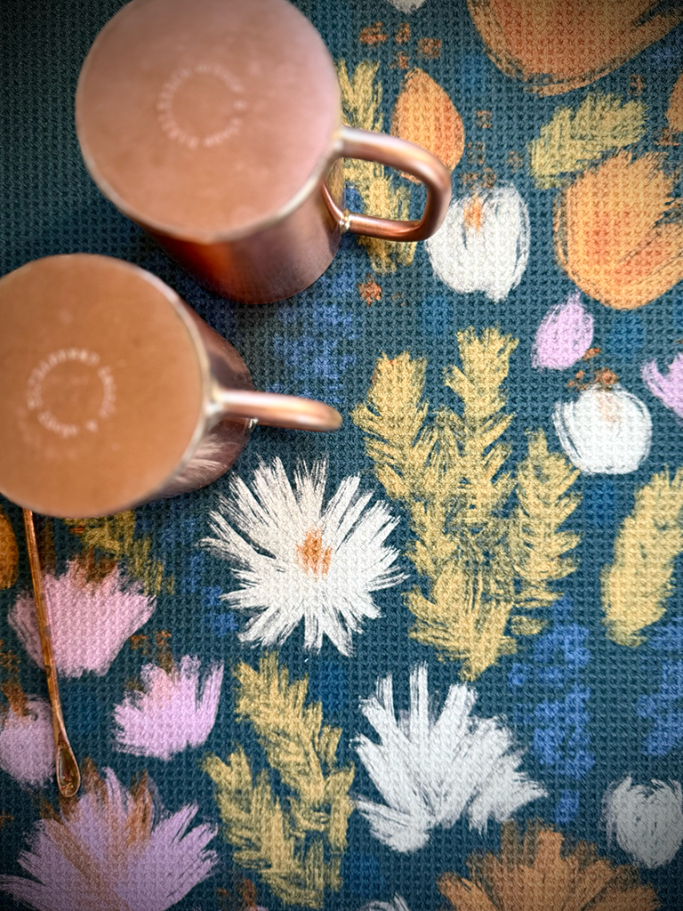 Copper mugs drying near the sink on the Wildflower multipurpose towel.