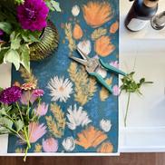 Wildflower multipurpose towel next to the sink catching trimmings and drips from a flower arrangement.
