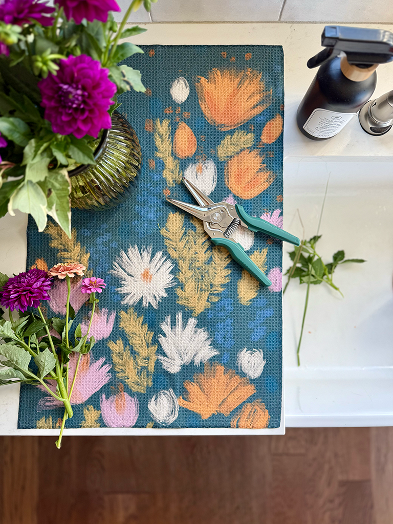 Wildflower multipurpose towel next to the sink catching trimmings and drips from a flower arrangement.