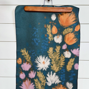 Full view of the colorful Wildflower multipurpose towel designed from verse Luke 12:27-31.