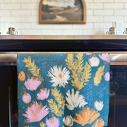 Wildflower multipurpose towel hanging in the kitchen, bringing brightness to the space and to your mind.