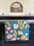 Wildflower multipurpose towel hanging in the kitchen, bringing brightness to the space and to your mind.
